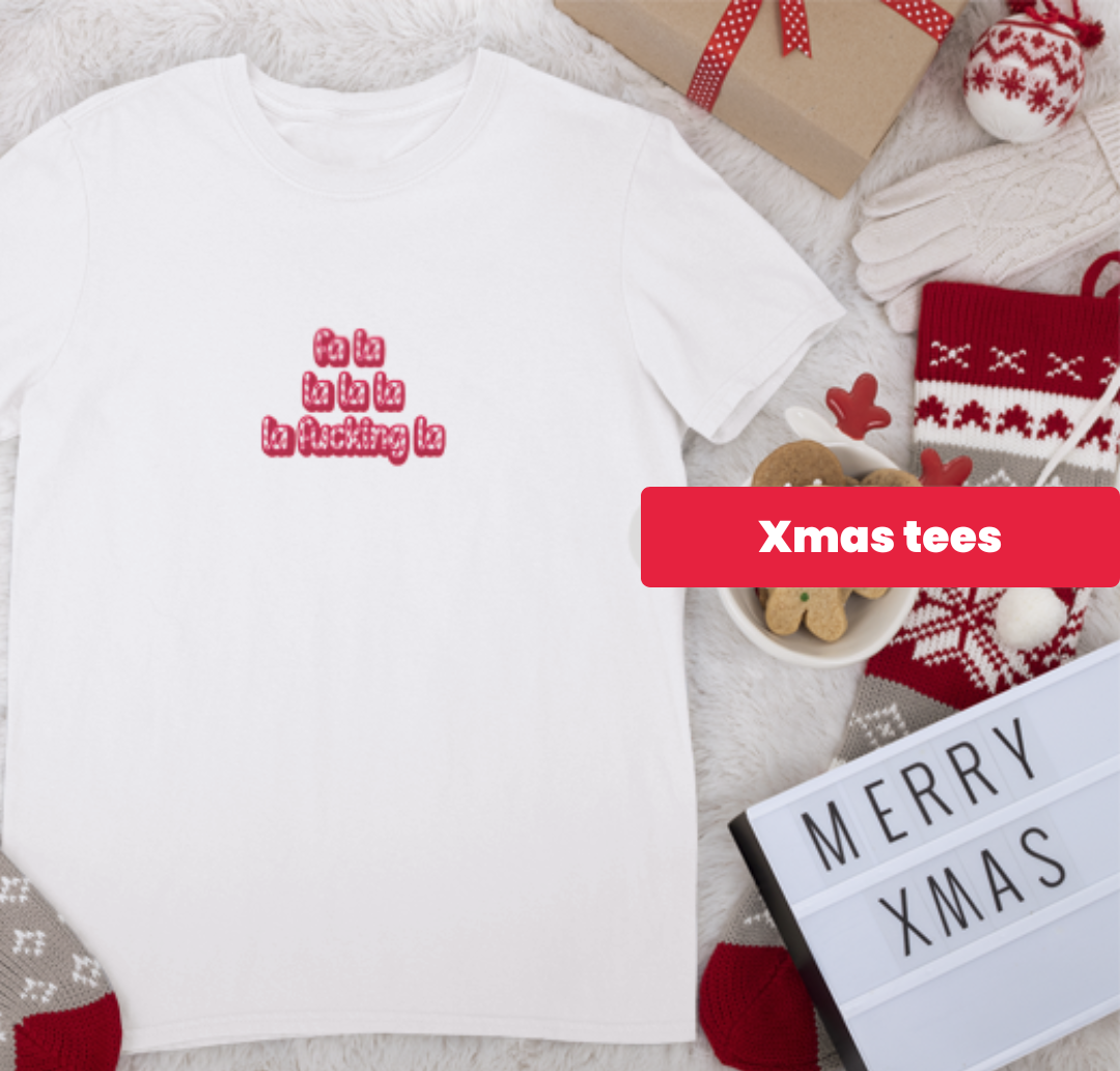 White t-shirt with Christmas-themed text and decorations on a light background